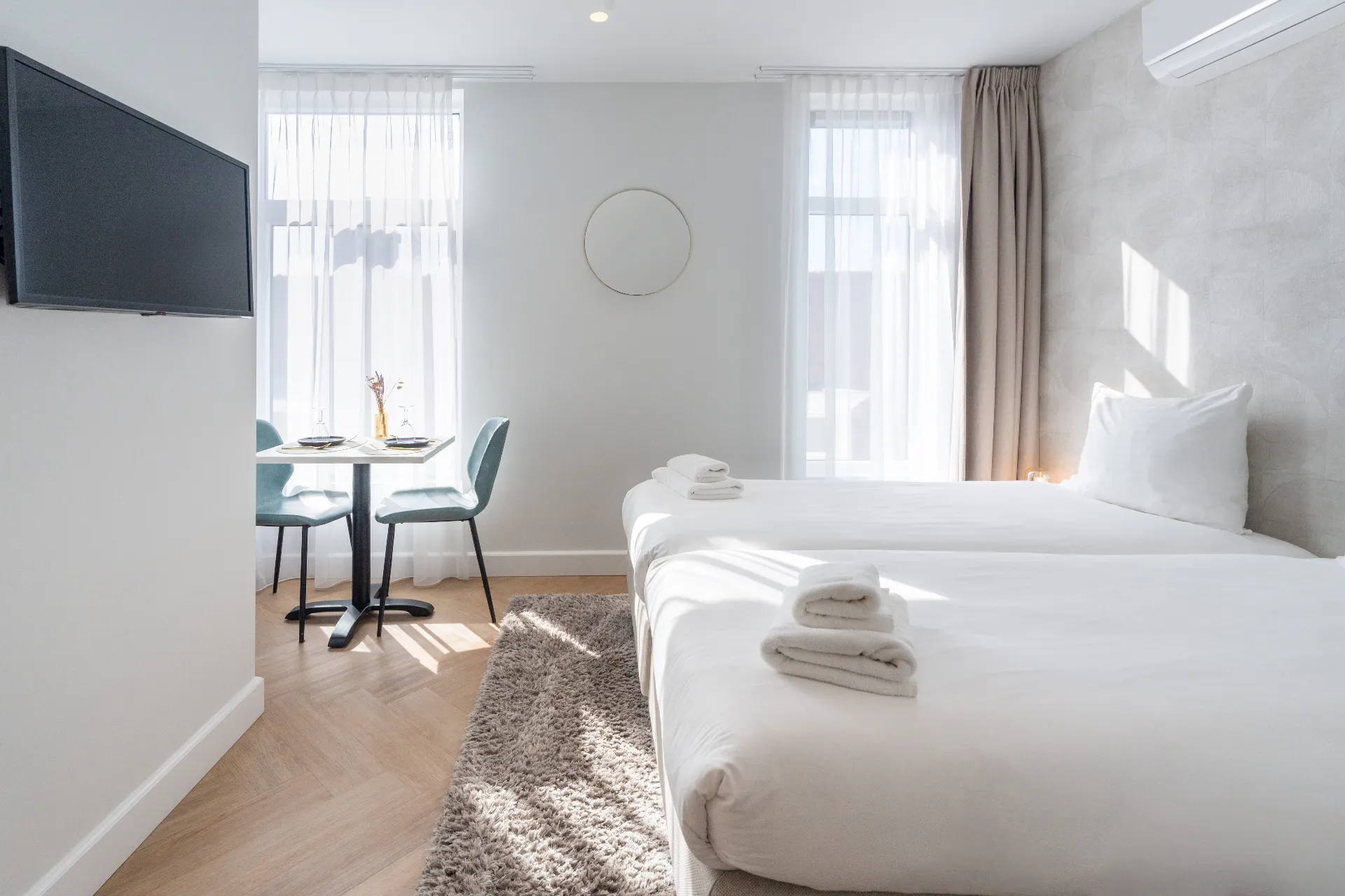 Twin room at Ocean House Zandvoort with serene neutral tones and natural light