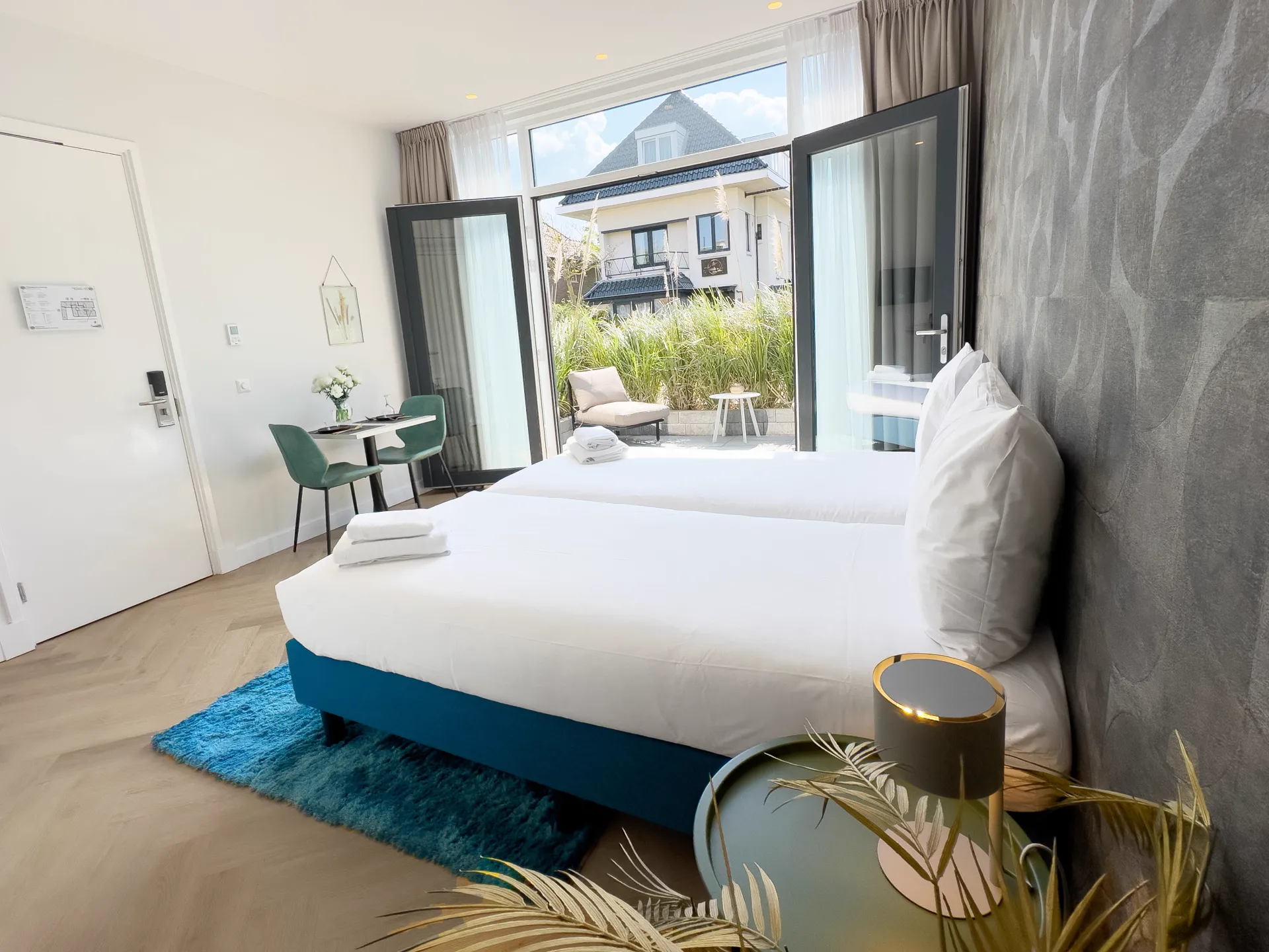 Terrace room at Ocean House Zandvoort opening onto a sun-drenched outdoor space